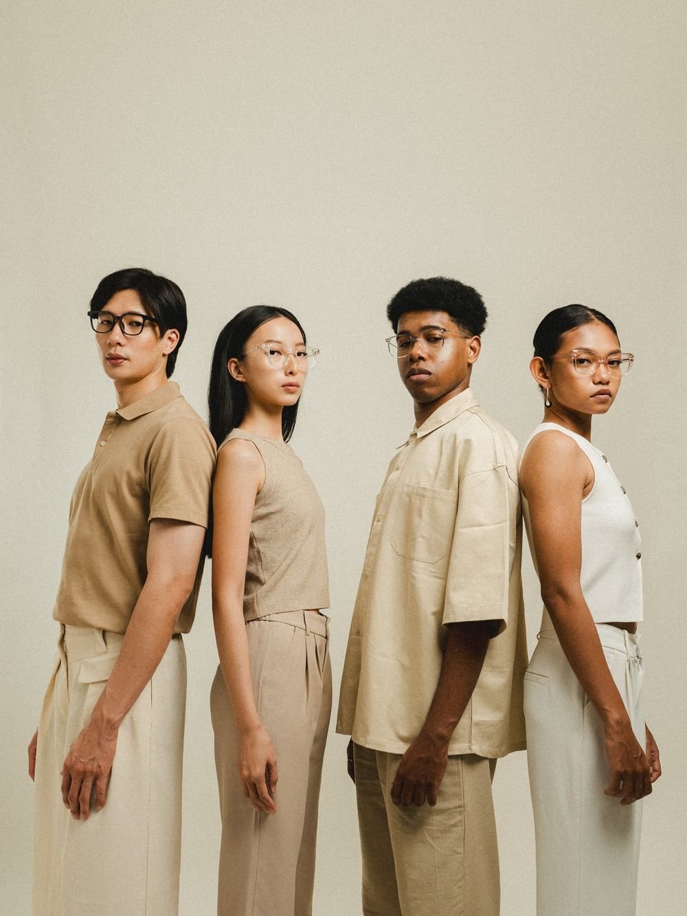 Four models standing back to back in glasses
