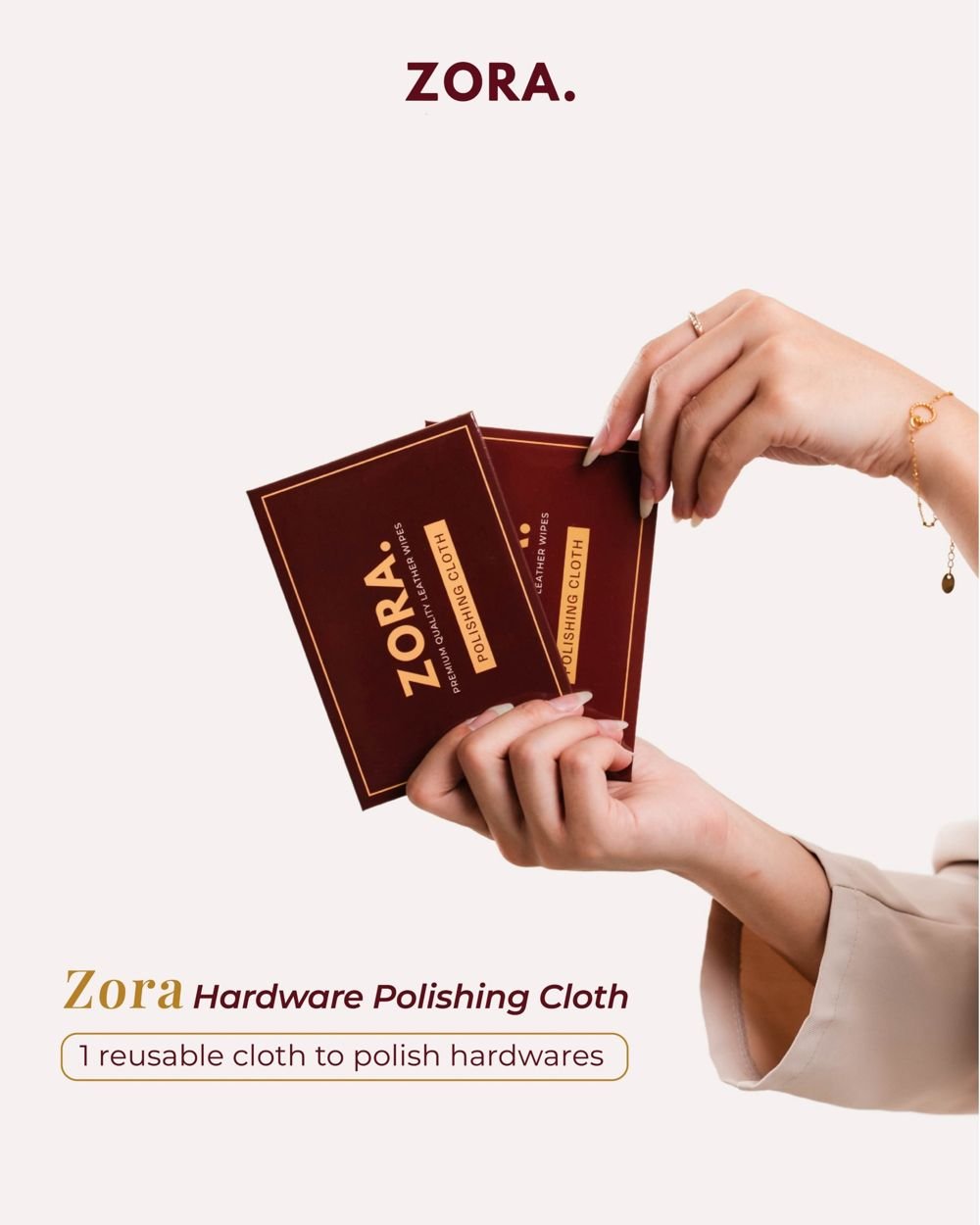 Hands fanning two ZORA polishing cloth packs